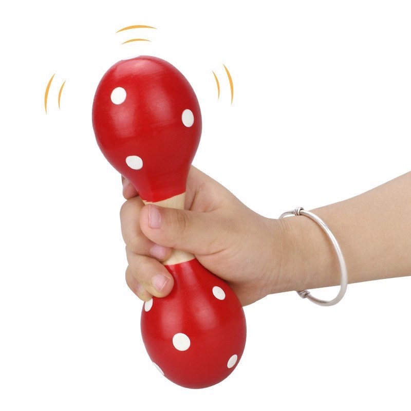 Presa agevole del sonaglio maracas da parte della manina del bambino